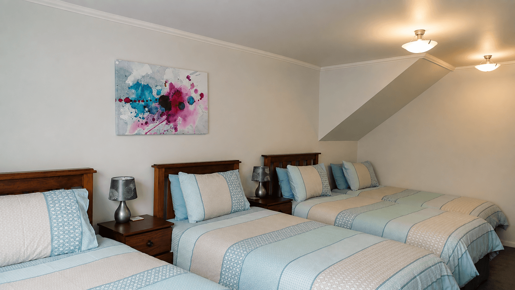 The larger bedroom set up with four beds for a short stay